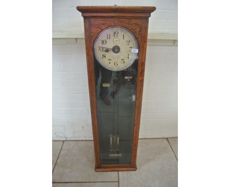 An oak cased National Electric master clock - 134cm tall x 42cm x 23cm - was working in vendors house
