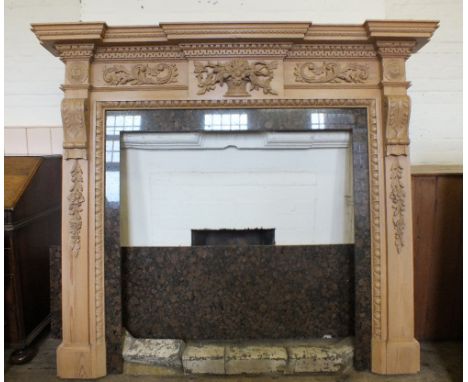 A modern carved Pine fire surround with floral appliques and rouge marble hearth and inner panels