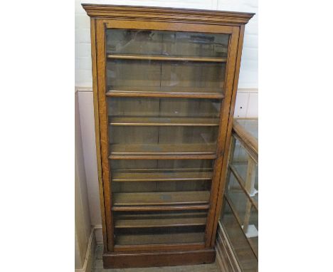 A glazed Oak seven shelf bookcase