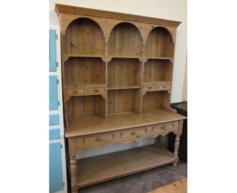 A modern Pine dresser with tiered back, seven drawers and low shelf