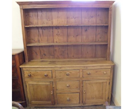 A Victorian Pine two shelf dresser over five drawers and two cupboards