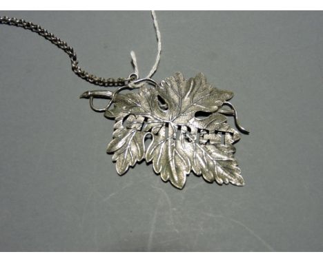A William IV cast silver claret decanter label modelled as a leaf, Birmingham, 1835.