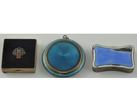 A silver and enamel square compact, the lid decorated with a flower basket, the gilt interior with a mirror and bearing UK im