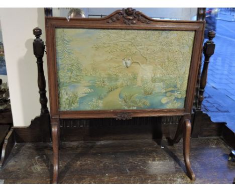 An Edwardian mahogany small firescreen inset silk thread panel worked with owls in a landscape.