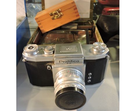 A vintage praktica 35mm camera, together with assorted optical accessories, magnifying lens, etc.