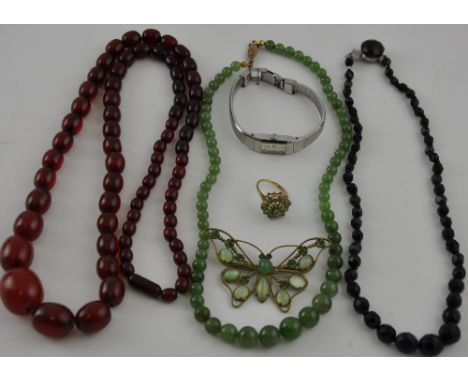 A graduated strand of jade beads, two further bead necklaces, butterfly brooch, 9ct green stone ring and a wristwatch.