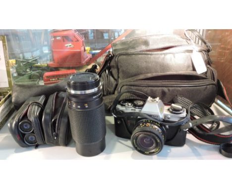 An Olympus CM10 camera with 28mm lens in soft case with additional 80 - 200mm telephoto and 48mm maero lenses, together with 