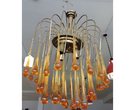 A 1970s brass ceiling light hung multiple amber glass drops.