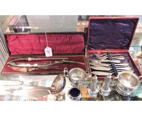 A cased Victorian horn handled three piece carving set, a pair of Edwardian plated fish servers, a rat tail ladle and sundry 