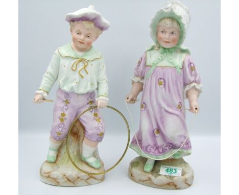 A pair of figurines of children playing: Height 31cm 
