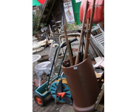 A collection of garden tools to include hose reel, seed sower, vintage and modern tool shears, rakes etc 