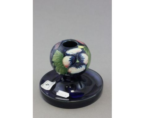 Moorcroft; a Moorcroft pottery candlestick in the Pansy pattern; bearing impressed and script mark to base