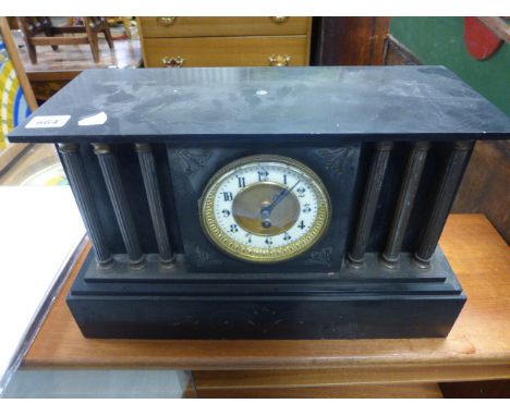 A large black slate architectural mantle clock