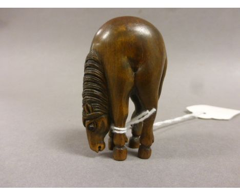 A fruitwood netsuke in the form of a horse