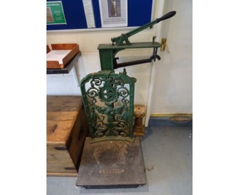 A set of late 19th century cast iron Bartlett & Sons floor standing weighing scales; with pierced decoration