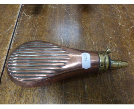 A vintage copper and brass powder flask; with ribbed decoration