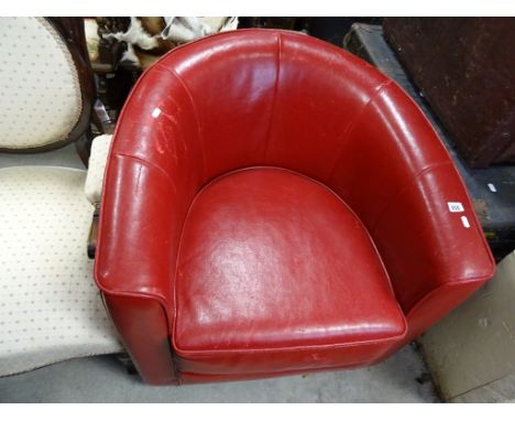A vintage red leather tub chair