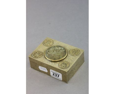 A small Chinese brass rectangular box; with engraved decoration; set with a well carved and pierced jade roundel 