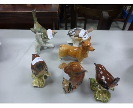 A collection of three Beswick pottery bird ornaments; together with two Goebel pottery birds and a Beswick pottery Corgi dog