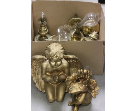 A box of brass oil lamp fittings; together with a pair of gold painted cherub figures and brass lamps