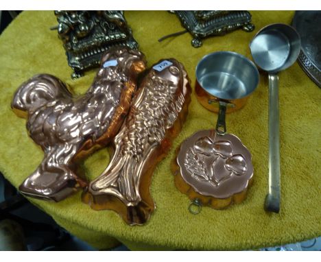 Three vintage copper jelly moulds; together with two small copper saucepans with brass handles