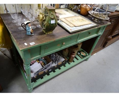 A painted and stripped pine side cabinet; with two drawers; with slotted shelf below; raised on turned supports