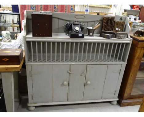 Kitchen cupboard with plate rack and shelf above