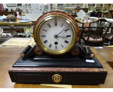 A late 19th century French marble and slate mantle clock; the white enamel dial with black painted Roman numerals 