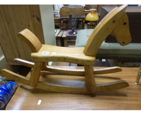A vintage child's stool in the form of a rocking horse
