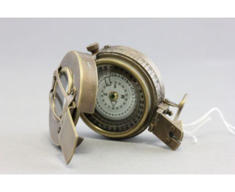 A brass compass marked T.G. Co Ltd London 1940 MK111 with military crows foot mark