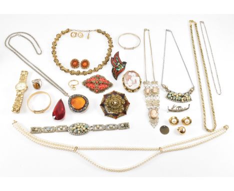 A collection of costume jewellery to include a carved cameo brooch, a yellow metal and orange stone necklace, a white metal f