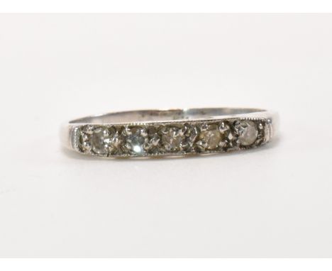 A hallmarked 9ct gold and diamond five stone ring. The ring being set with five round cut diamonds to a plain band. Hallmarke