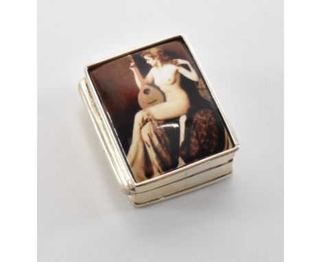 A silver pill box of rectangular form with an enamelled nude figure to the front. Marked sterling to the interior. Measures 3