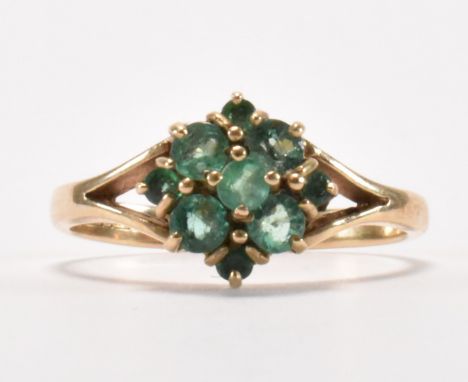 A hallmarked 9ct gold and&nbsp; emerald cluster ring. The ring being set with nine round cut emerald having&nbsp; &nbsp;split