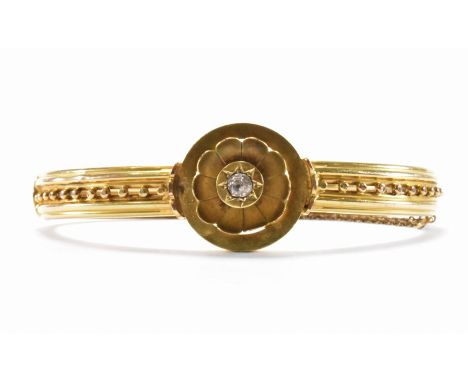A 19th Century Victorian 15ct gold and diamond hinged bangle bracelet. The bracelet having a central round panel with floral 