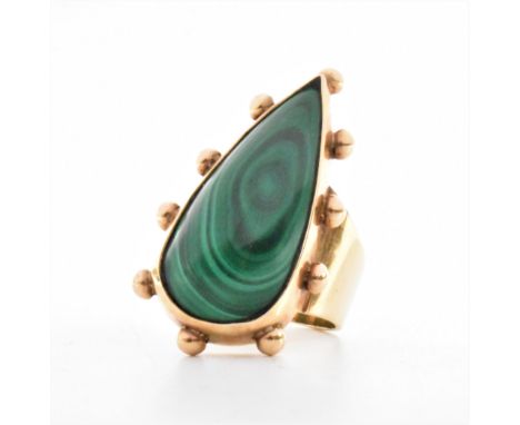 A vintage 1960s hallmarked 9ct gold and malachite dress ring. The ring being bezel set with a tear drop shaped cabochon on a 