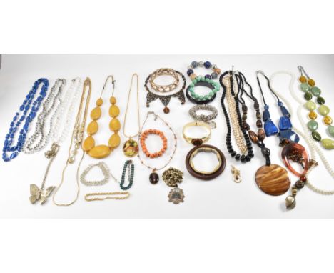 A collection of vintage costume jewellery to include plastic beaded necklaces, yellow metal bracelets, beaded bracelets, pend