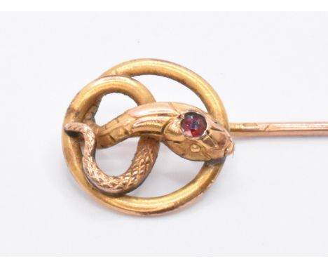 A 19th Century Victorian gold stick pin having a finial in the form of a coined snake with a round cut red stone set to the h
