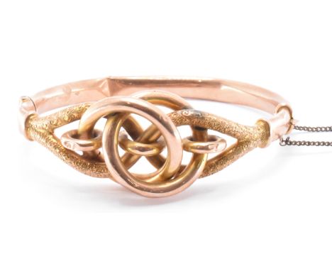 A 19th Century Victorian 9ct gold bangle bracelet having a knot design with engraved details. The antique bracelet having a h