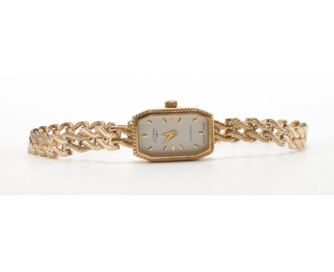 A hallmarked 9ct gold Rotary Quartz cocktail watch. The watch having a rectangular face with a white dial and baton numerals 