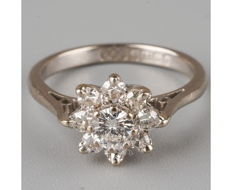 An 18ct white gold and diamond cluster ring, set with a round brilliant-cut diamond approx 0.2ct, surrounded by six smaller d