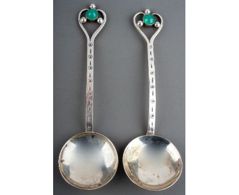 A pair of Arts &amp; Crafts silver spoons, stylised heart shaped openwork terminals with jade coloured cabochons and silver b