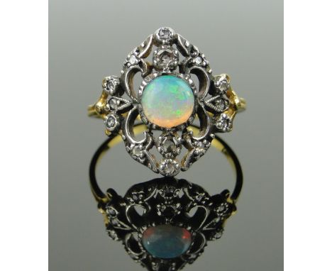 An opal and diamond set open work panel ring,
setting height 16mm, size O.