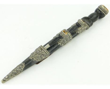 A 19th century Scottish Dirk,
with carved stained wood handles, inset Cairngorms, and thistle decorated plated mounts, length