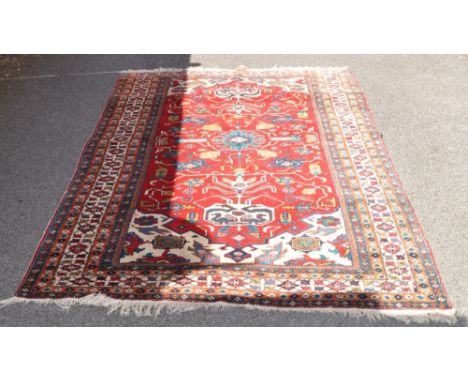 A red ground hand woven Ardebil carpet,
9' x 5'5" with original paperwork.