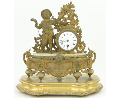 A 19th century gilt metal mantel clock,
surmounted with a boy and butterfly, sitting on a shaped stand with pendulum and key,