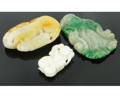 A carved white jade figure, height 2",
a green jade pendant in the form of a figure, and another, (3).