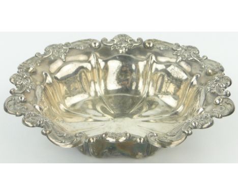An Edwardian circular silver fruit bowl,
with relief decorated scroll and floral surround, import marks for Birmingham 1906, 