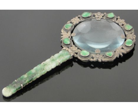 A Chinese silver magnifying glass,
with relief carved and pierced jade handle and small jade insets, length 14.5cm.