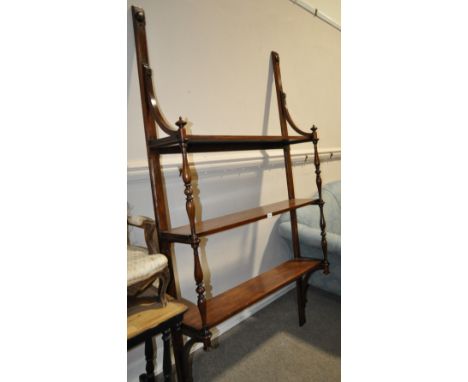 A 19th century mahogany hanging 3-tier shelf,
with turned columns, height 6'5", width 3'8", depth 10.5" overall.